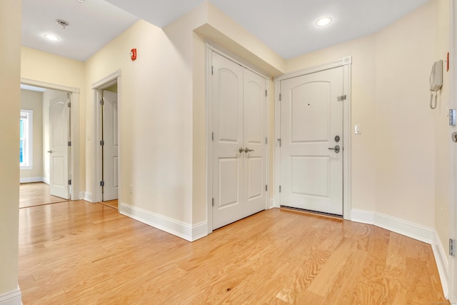 entrance foyer with light wood-style flooring and baseboards