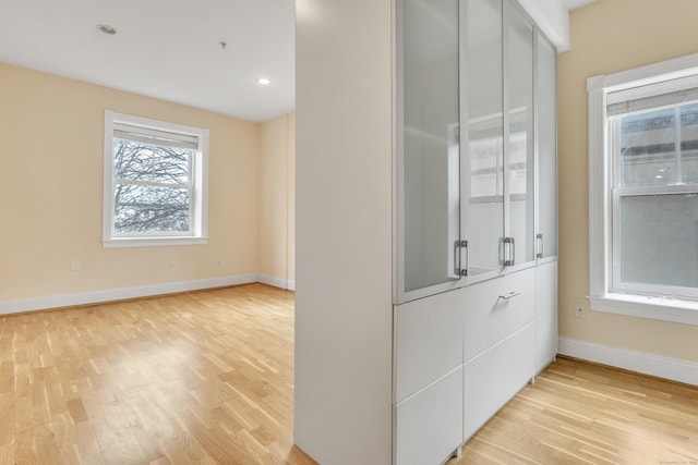 interior space with light wood-style flooring, baseboards, and recessed lighting