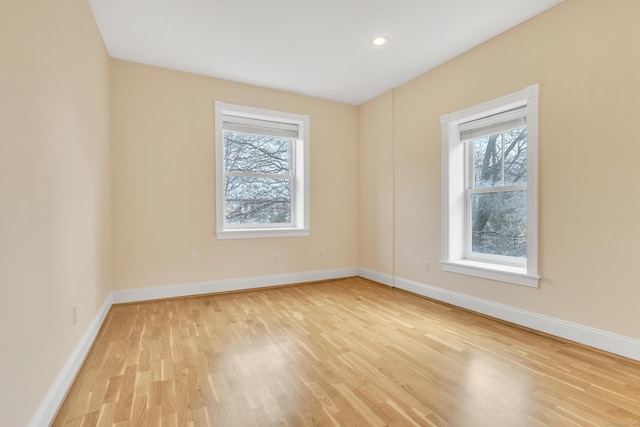 unfurnished room with recessed lighting, baseboards, and light wood finished floors