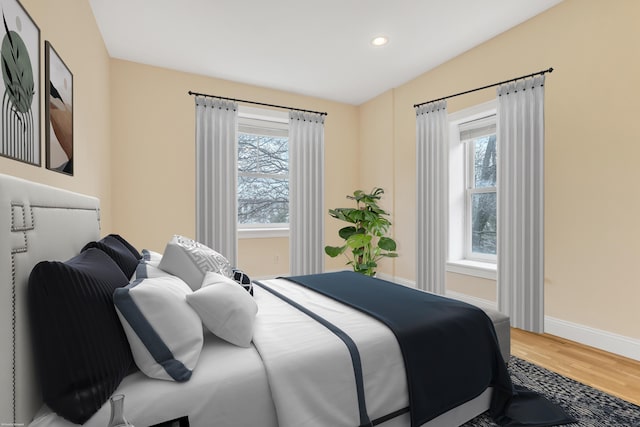 bedroom featuring multiple windows, recessed lighting, wood finished floors, and baseboards