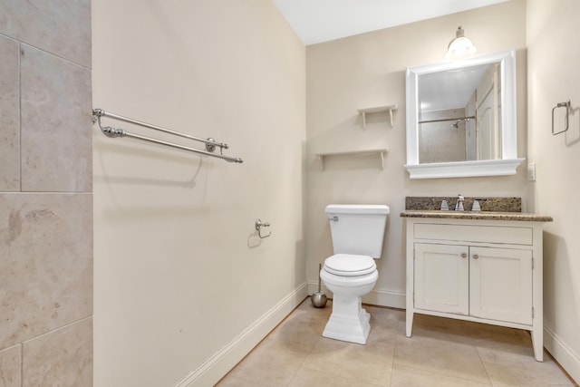 bathroom with toilet, vanity, tile patterned flooring, baseboards, and walk in shower