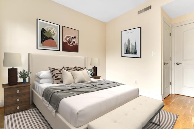 bedroom featuring light wood-type flooring, baseboards, and visible vents