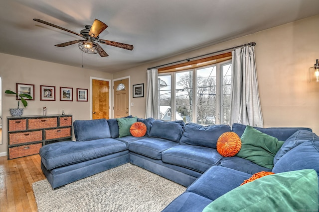 living area with light wood finished floors and a ceiling fan