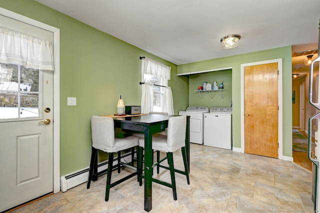 dining space with washer and dryer, baseboards, and baseboard heating