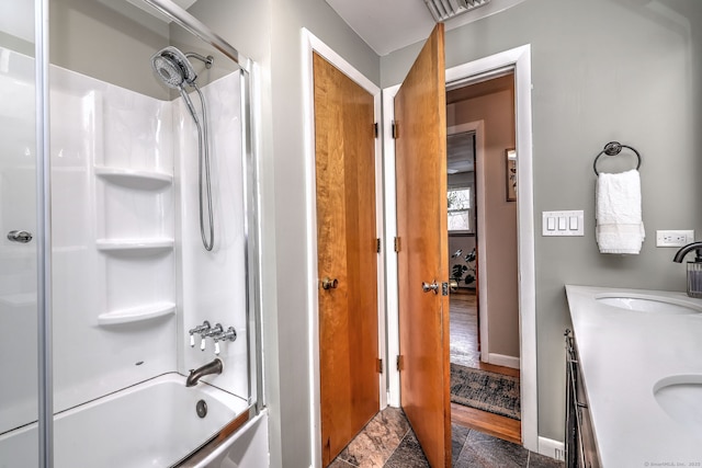 full bathroom with double vanity, baseboards, visible vents,  shower combination, and a sink