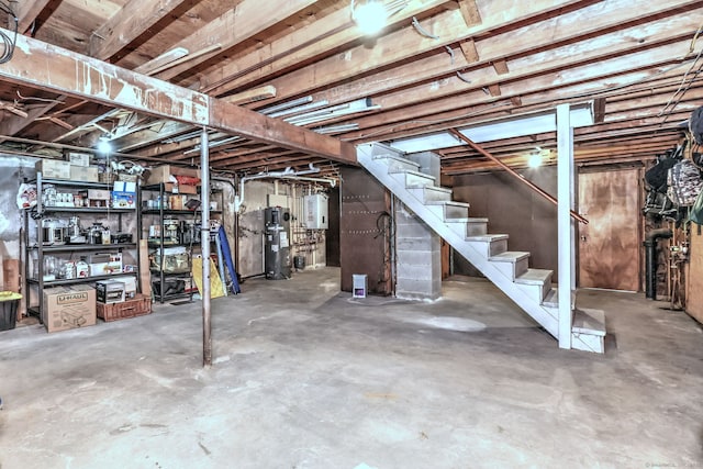 unfinished basement with water heater and stairway