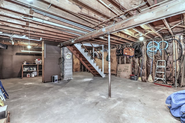 unfinished basement featuring stairway