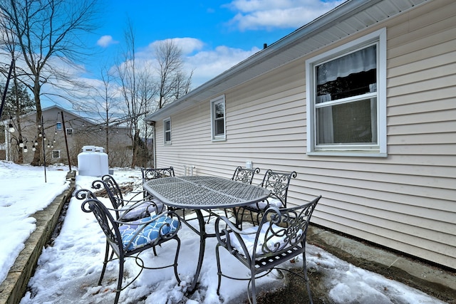 snow covered patio featuring outdoor dining space