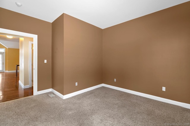 empty room with carpet floors and baseboards