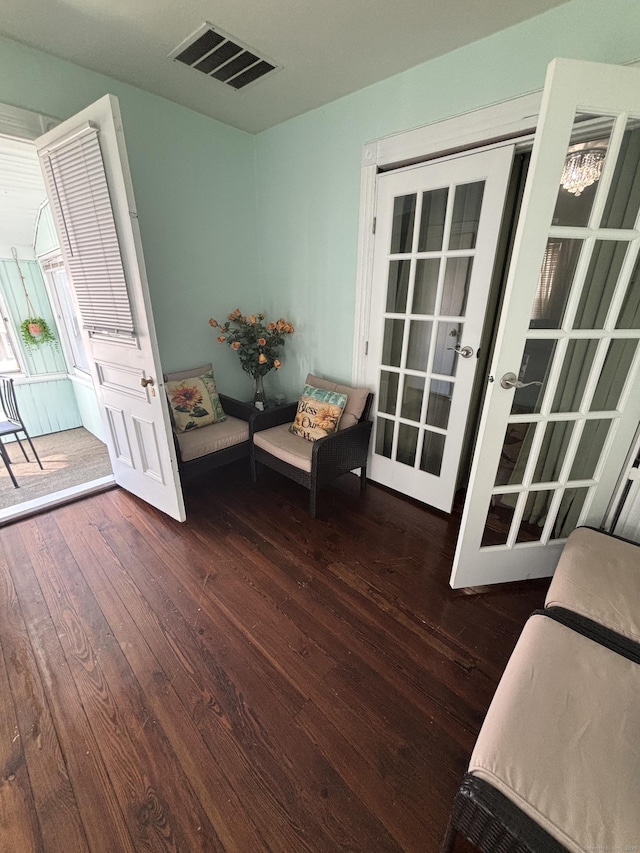 unfurnished room featuring french doors, visible vents, and dark wood finished floors