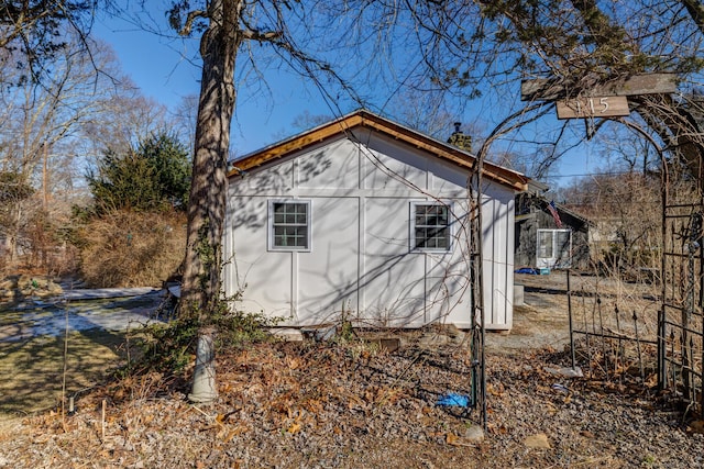 view of home's exterior with an outdoor structure