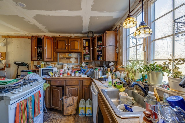 kitchen with white appliances, dark wood-style flooring, a sink, open shelves, and pendant lighting