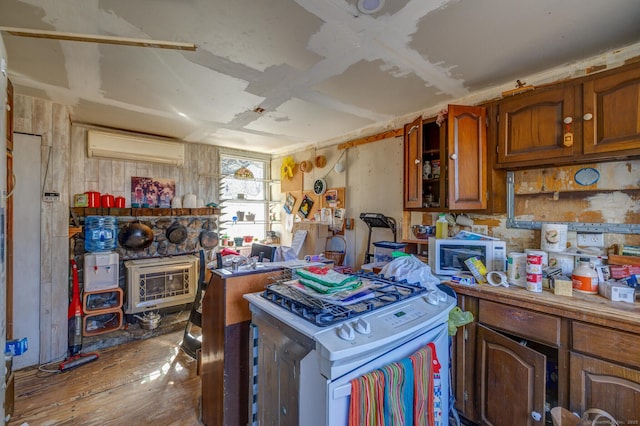 kitchen with white appliances, brown cabinetry, an AC wall unit, and light countertops