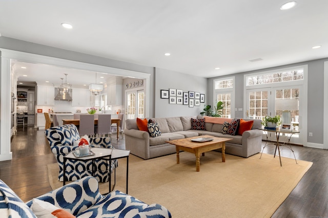 living room featuring recessed lighting, baseboards, and wood finished floors