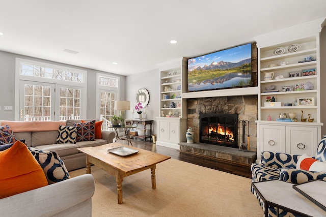 living room with a fireplace, plenty of natural light, wood finished floors, and recessed lighting