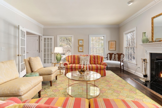 living area featuring baseboards, french doors, a fireplace, and crown molding