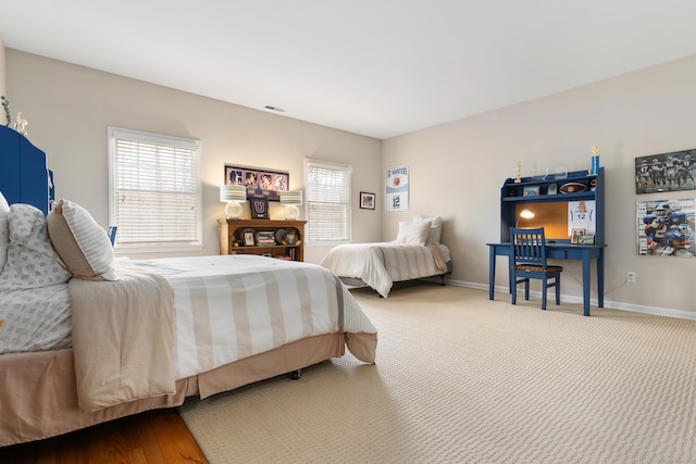 carpeted bedroom featuring baseboards