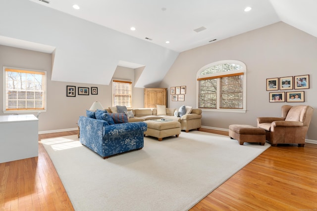 living area featuring lofted ceiling, baseboards, wood finished floors, and recessed lighting