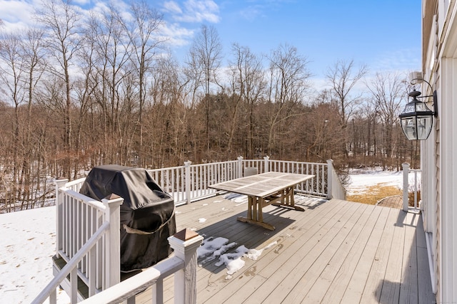 snow covered deck with outdoor dining space