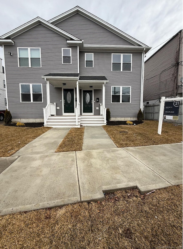 view of front of property featuring fence