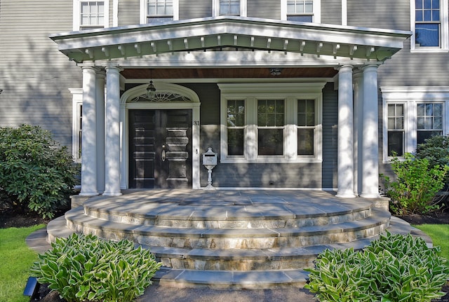 view of exterior entry featuring a porch