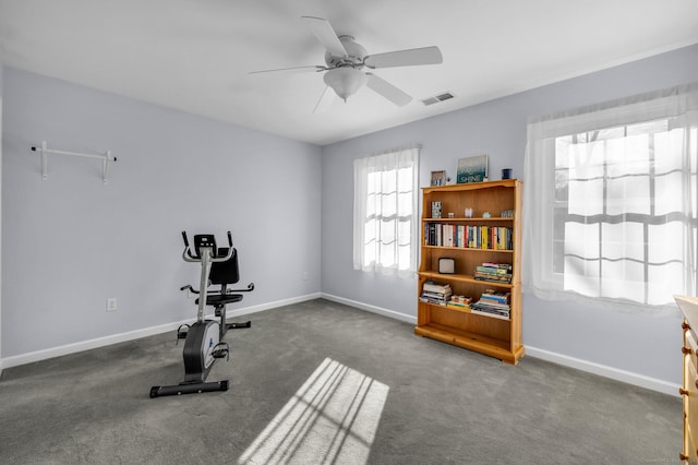 workout room featuring visible vents, baseboards, and a ceiling fan