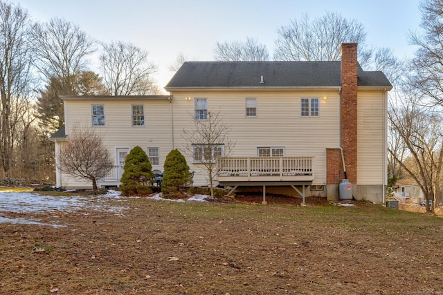 rear view of property featuring a deck and a chimney