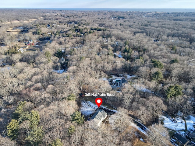 drone / aerial view with a wooded view