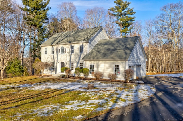 view of front of home with aphalt driveway and an attached garage