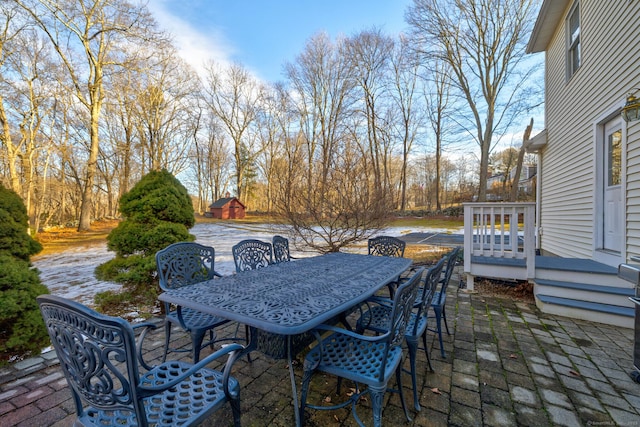 view of patio / terrace with a deck and outdoor dining space