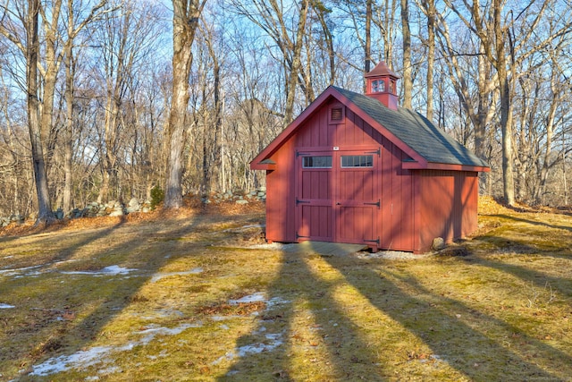 view of shed with a wooded view