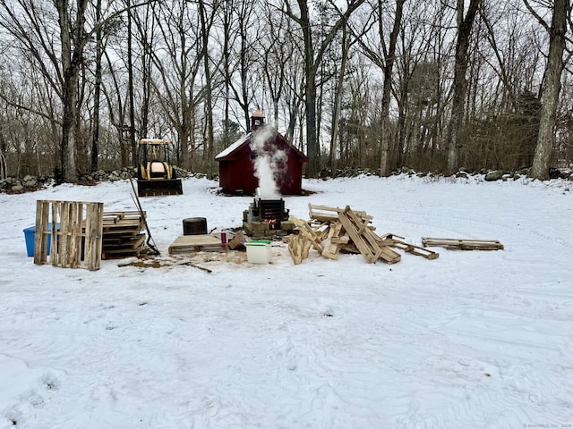 snowy yard featuring a garage