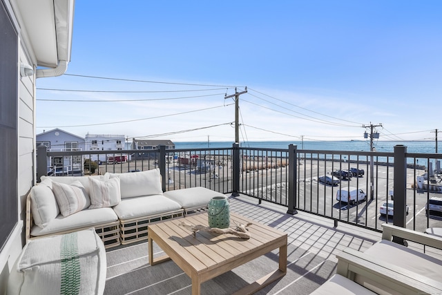 deck featuring a water view and an outdoor living space