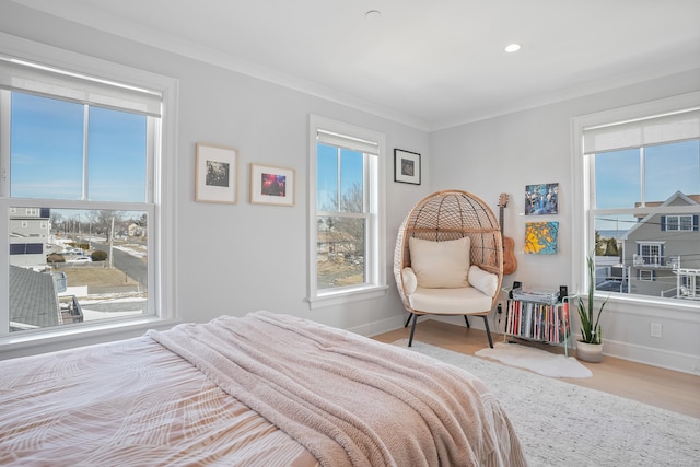 bedroom with ornamental molding, light wood-type flooring, baseboards, and recessed lighting