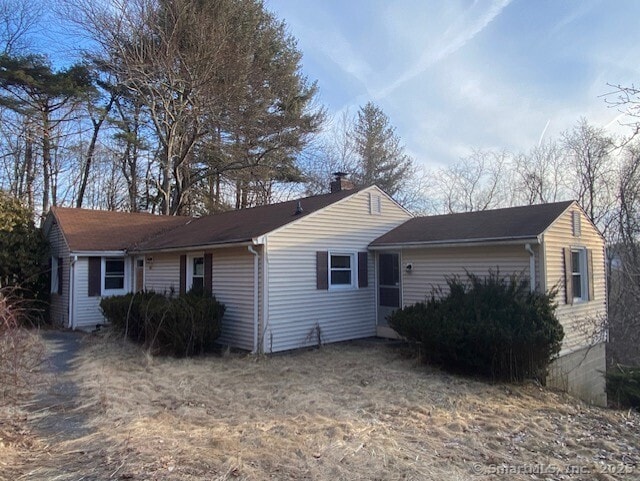 view of property exterior with a chimney