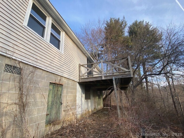 view of side of home with a wooden deck