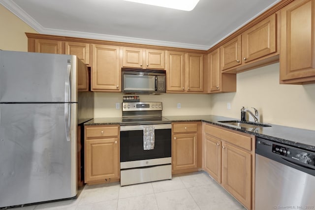 kitchen with light tile patterned floors, dark stone countertops, stainless steel appliances, crown molding, and a sink