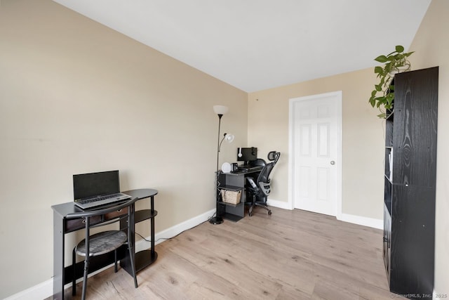 office featuring light wood-type flooring and baseboards