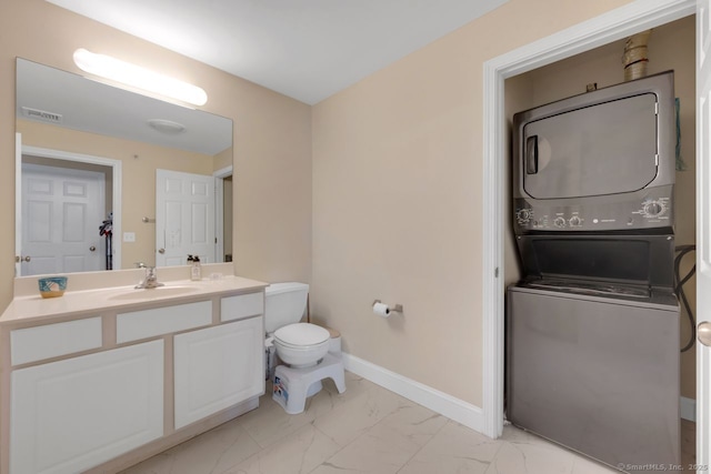 half bathroom featuring marble finish floor, stacked washer / drying machine, visible vents, toilet, and baseboards