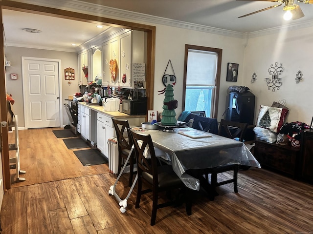 dining room featuring light wood-style floors, a ceiling fan, and crown molding