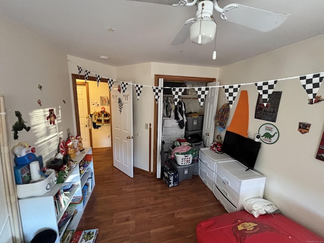 bedroom with ceiling fan, a closet, and dark wood-style flooring