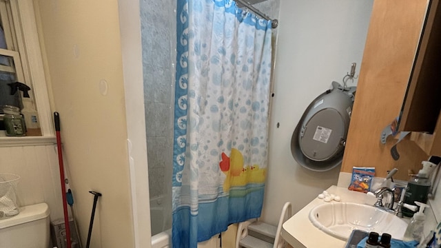 bathroom with vanity, shower / bath combo with shower curtain, and toilet