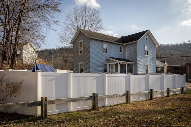 back of property with a fenced backyard