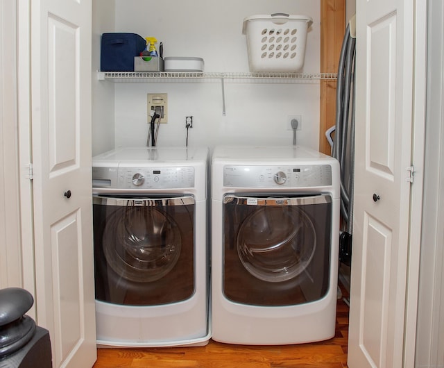 laundry area featuring laundry area, washing machine and dryer, and light wood finished floors