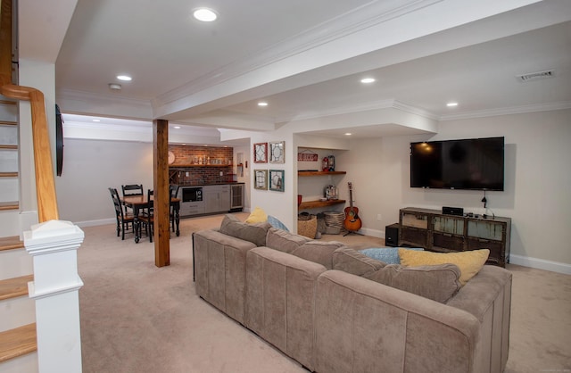 living area with visible vents, bar, light colored carpet, and ornamental molding