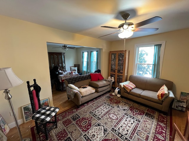 living room with ceiling fan and wood finished floors