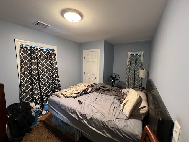 bedroom with visible vents and wood finished floors