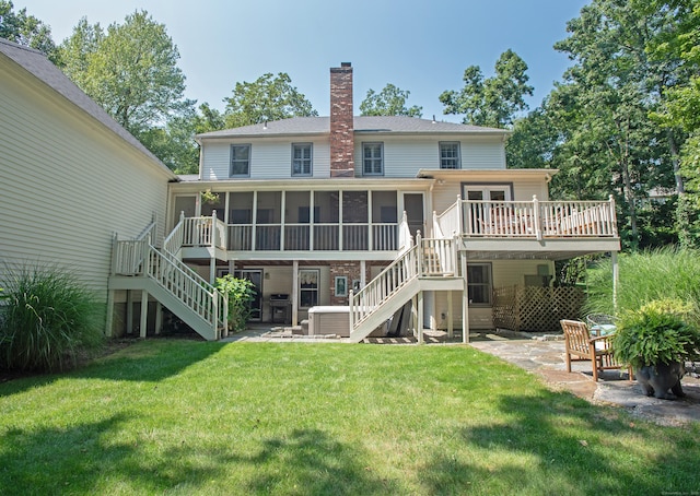 back of property with a sunroom, stairs, a chimney, and a patio