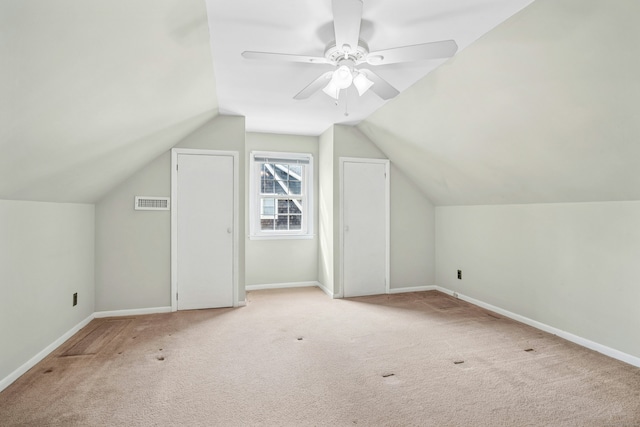 bonus room featuring baseboards, ceiling fan, lofted ceiling, and light colored carpet