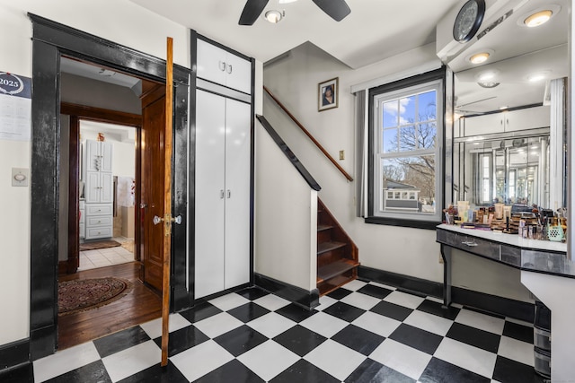 foyer featuring stairs, a ceiling fan, baseboards, and tile patterned floors